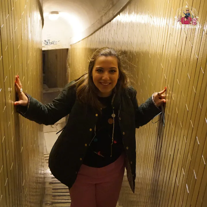 The author with her hands on both walls of a narrow, sloping corridor in the final stretch of the dome climb