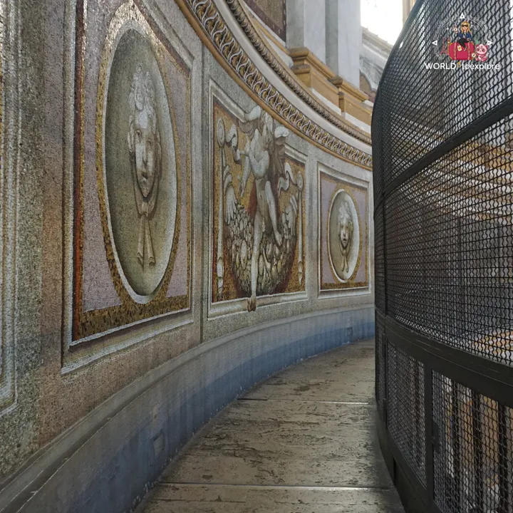 The curved corridor inside the drum of the dome, with mosaics of angels and mascarons on the walls