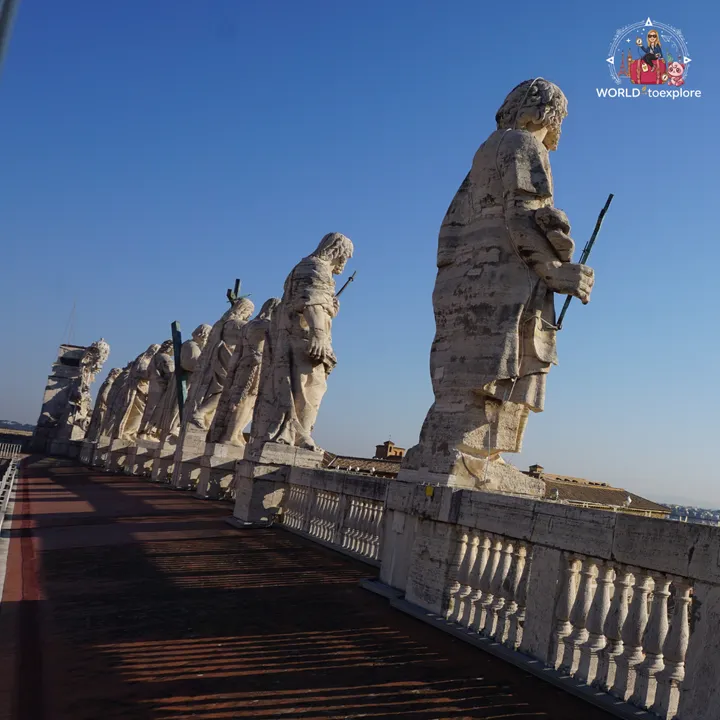 The statues of the apostles lined up along the balustrade of the basilica roof, seen from the terrace