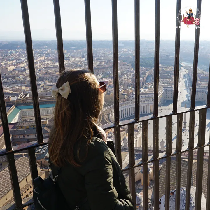The author looking out over St Peter's Square through the bars at the top of the dome, with the colonnade and the avenue beyond