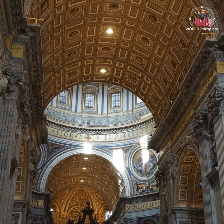 The gilded coffered vault of the central nave, with the Latin inscription running beneath the dome