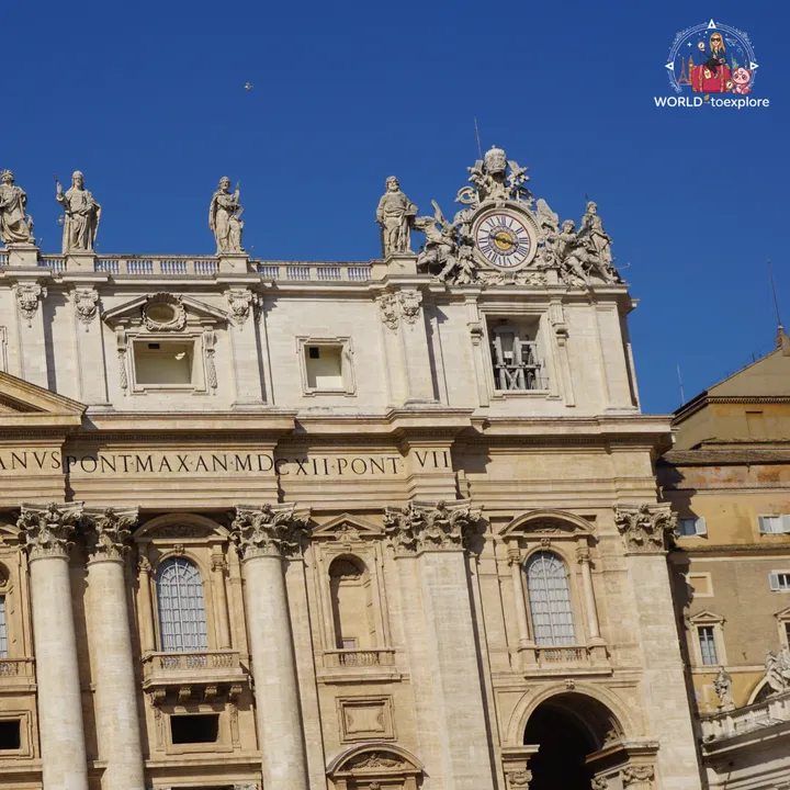 Detail of the façade of St Peter's Basilica, with the clock, the papal coat of arms and the statues above the balustrade