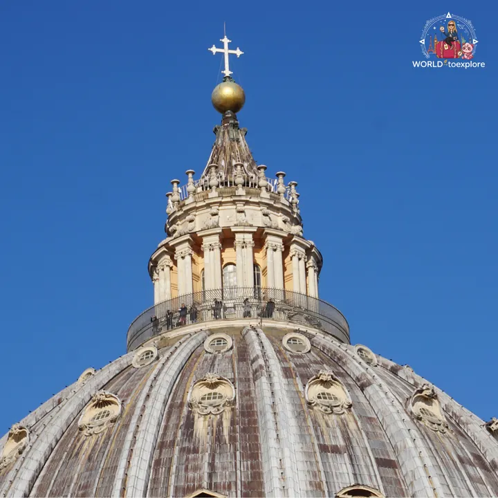 The lantern at the top of the dome of St Peter's Basilica, with the golden sphere and cross, and visitors on the balcony around it