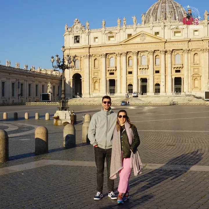 The author and her partner in a deserted St Peter's Square in the early morning, with the basilica façade behind them