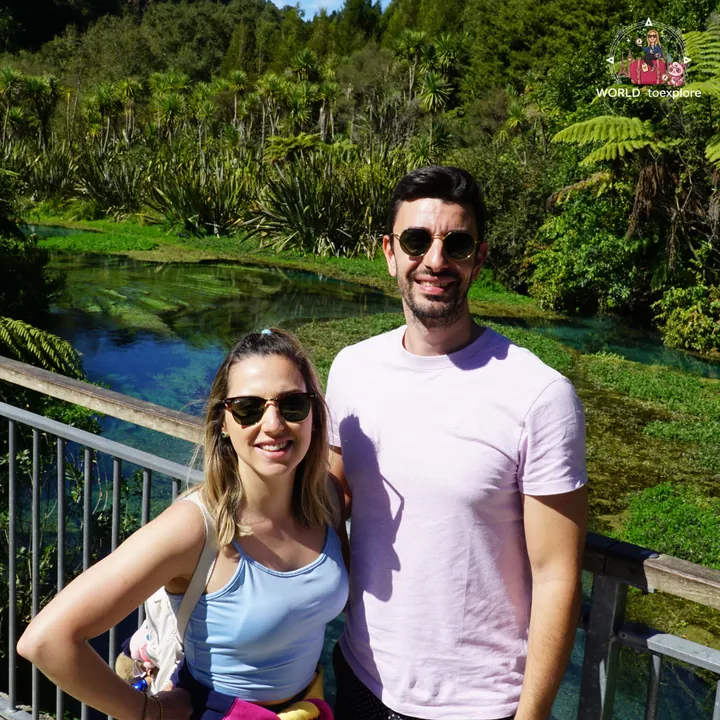 The author and her partner on the Blue Spring viewing bridge, with the blue-turquoise water and native vegetation behind them