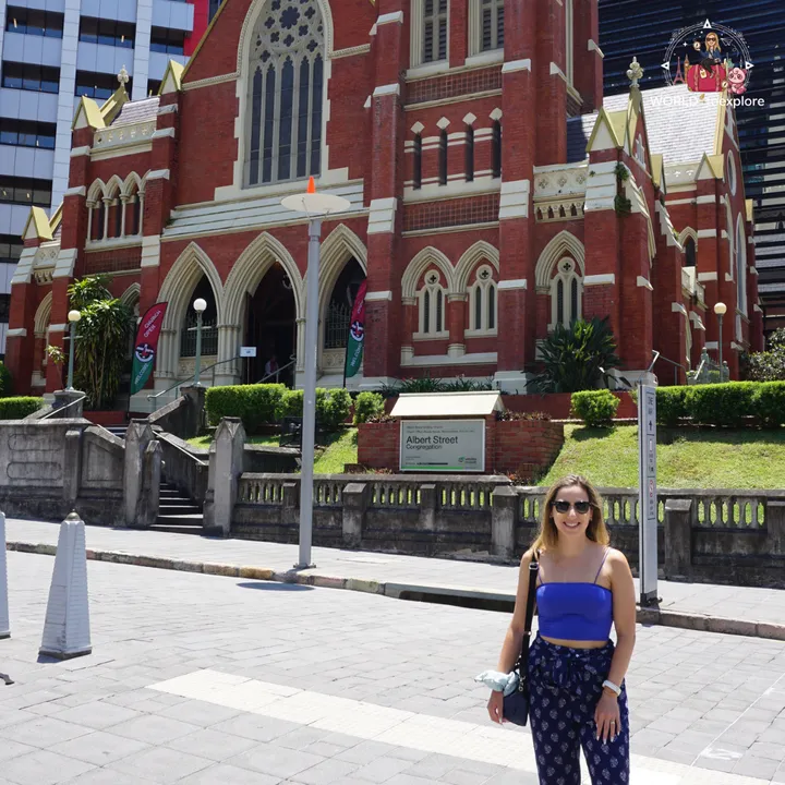 Albert Street Uniting Church, a brick church in the neo-Gothic style, surrounded by skyscrapers in central Brisbane