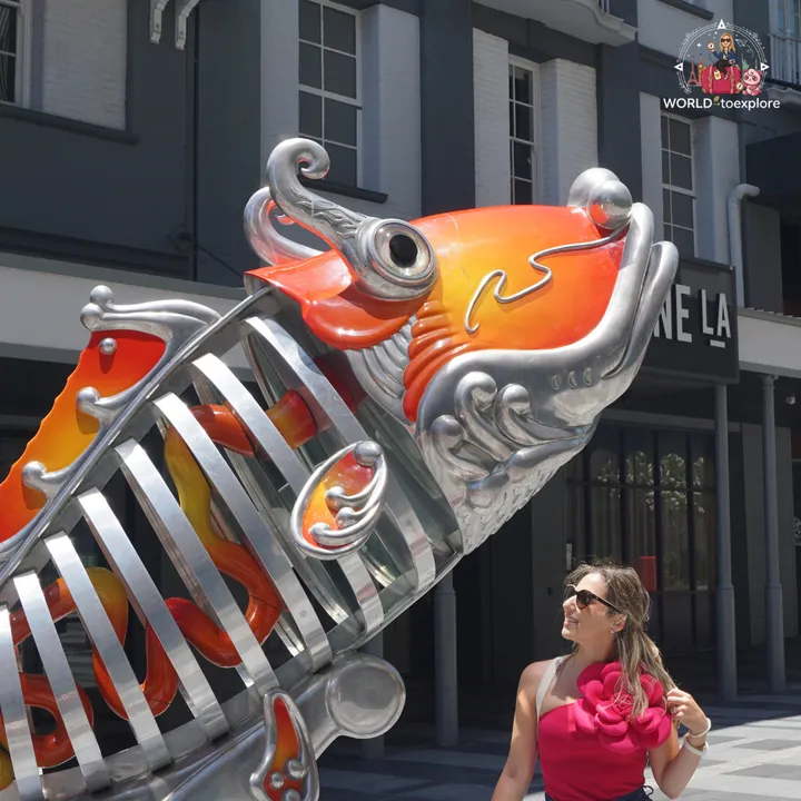 Looking at the colourful metal carp sculpture, in Fortitude Valley