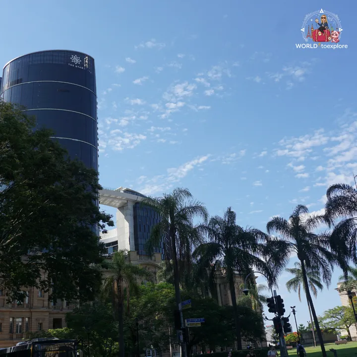 The Star tower and heritage buildings flanked by palm trees, in central Brisbane