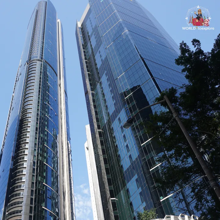 Two glass skyscrapers in central Brisbane seen from below