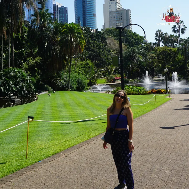 Beside the striped lawn and the lake fountains, with the Brisbane skyscrapers behind