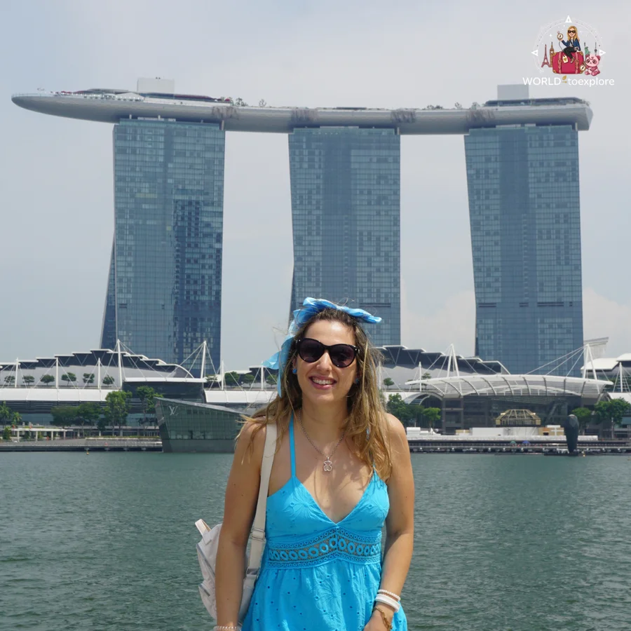 In front of Marina Bay in Singapore, with the three towers of Marina Bay Sands and the boat-shaped terrace on top