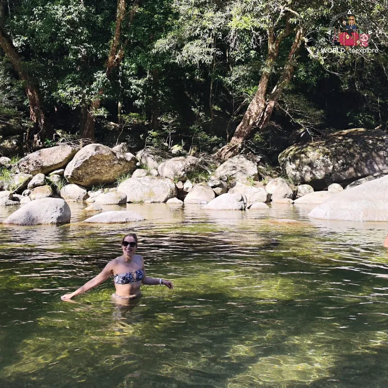 Taking a dip in the natural pool at Mossman Gorge, among granite boulders