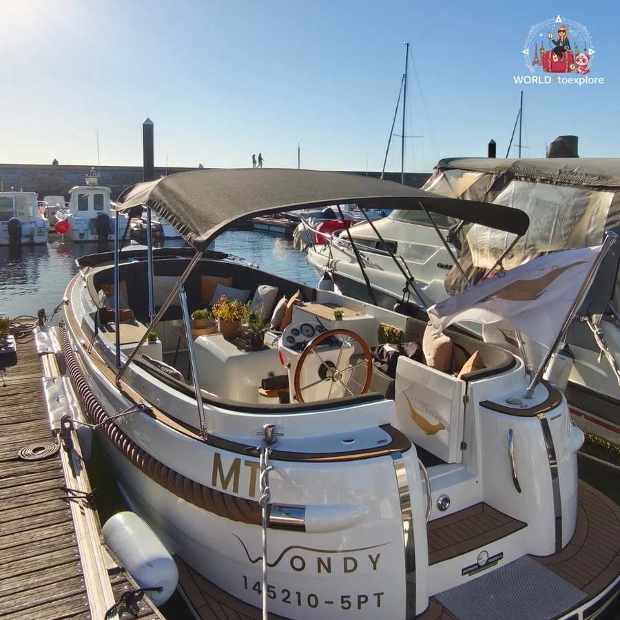 The Wondy moored at a pontoon at Douro Marina, in Afurada, with its name on the stern and the helm and seats in view