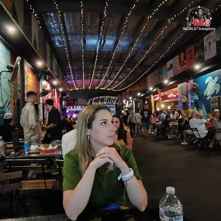 At a table in Miami Marketta, among food stalls and colourful murals