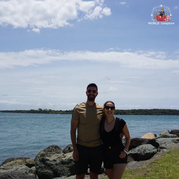 By the rocks of the Gold Coast Seaway, with the channel and sea behind