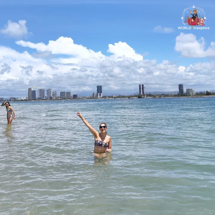 In the water at a Gold Coast beach, with the skyscrapers in the background