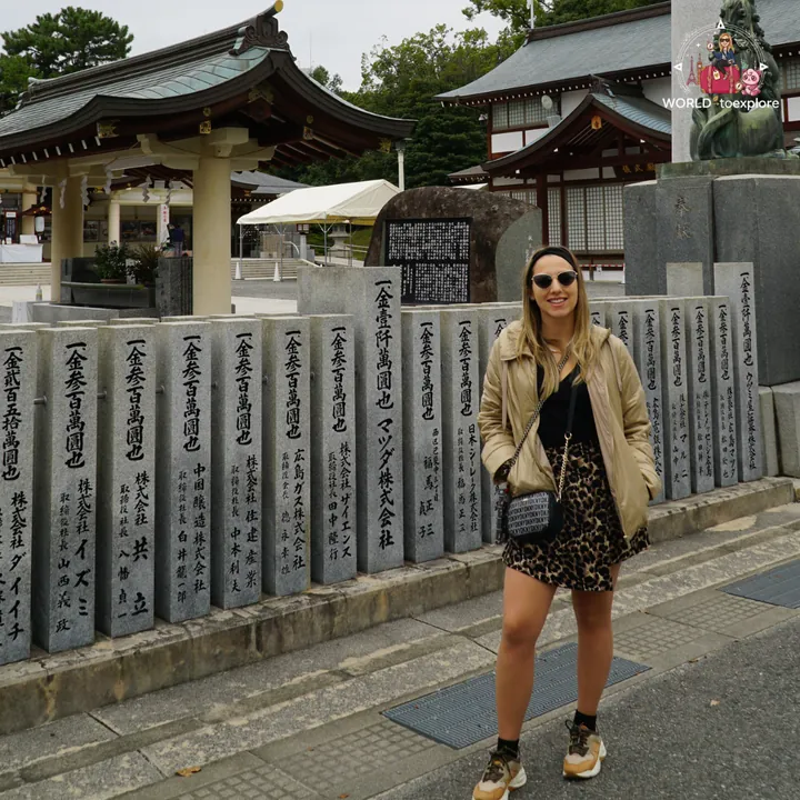 Beside the engraved stone steles of Hiroshima Gokoku Shrine