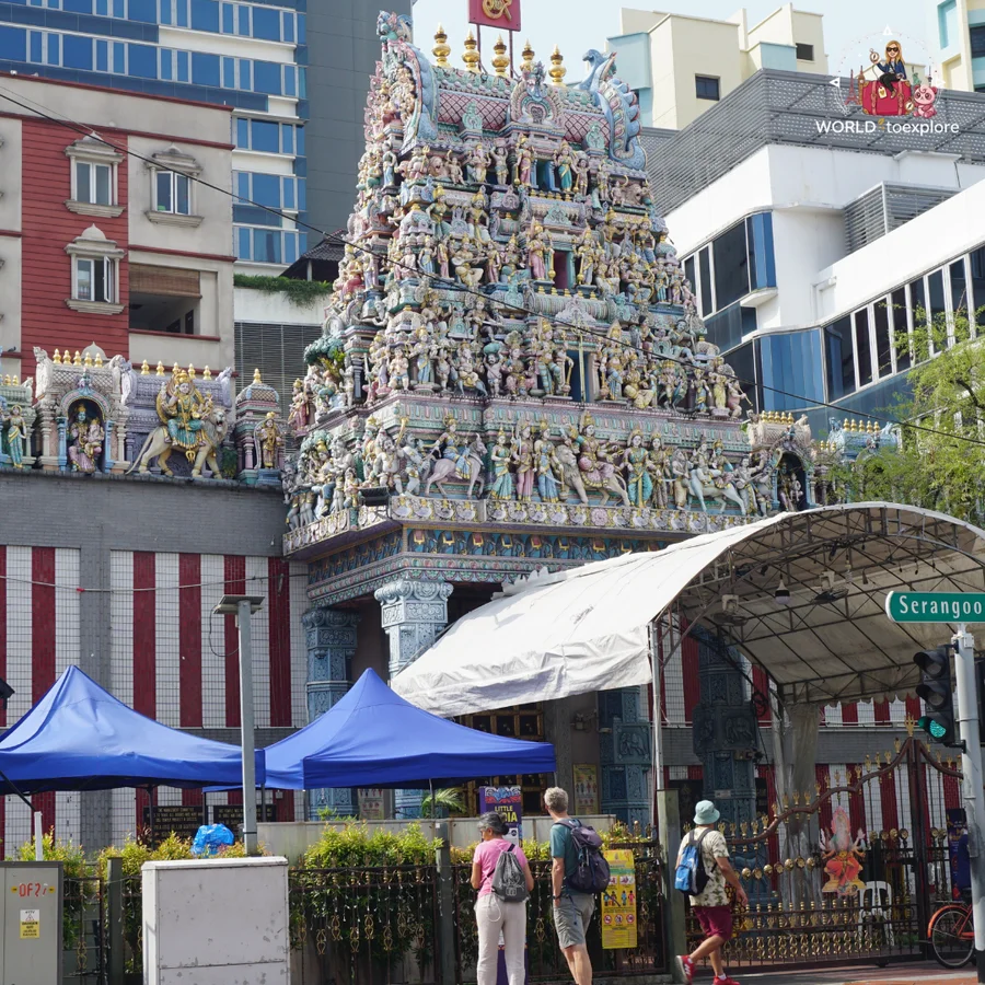 The tower of the Sri Veeramakaliamman Hindu temple, covered in colourful sculptures of deities, on Serangoon Road, in Little India