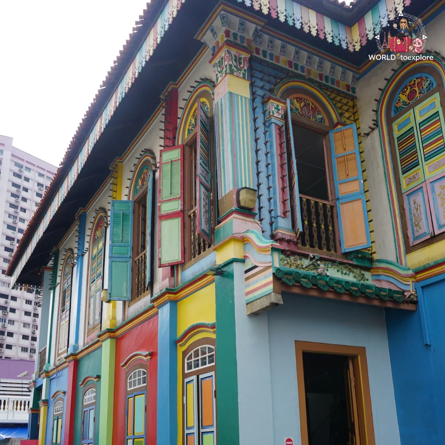 The colourful façade of the House of Tan Teng Niah, in Little India, with blue, green and red shuttered windows