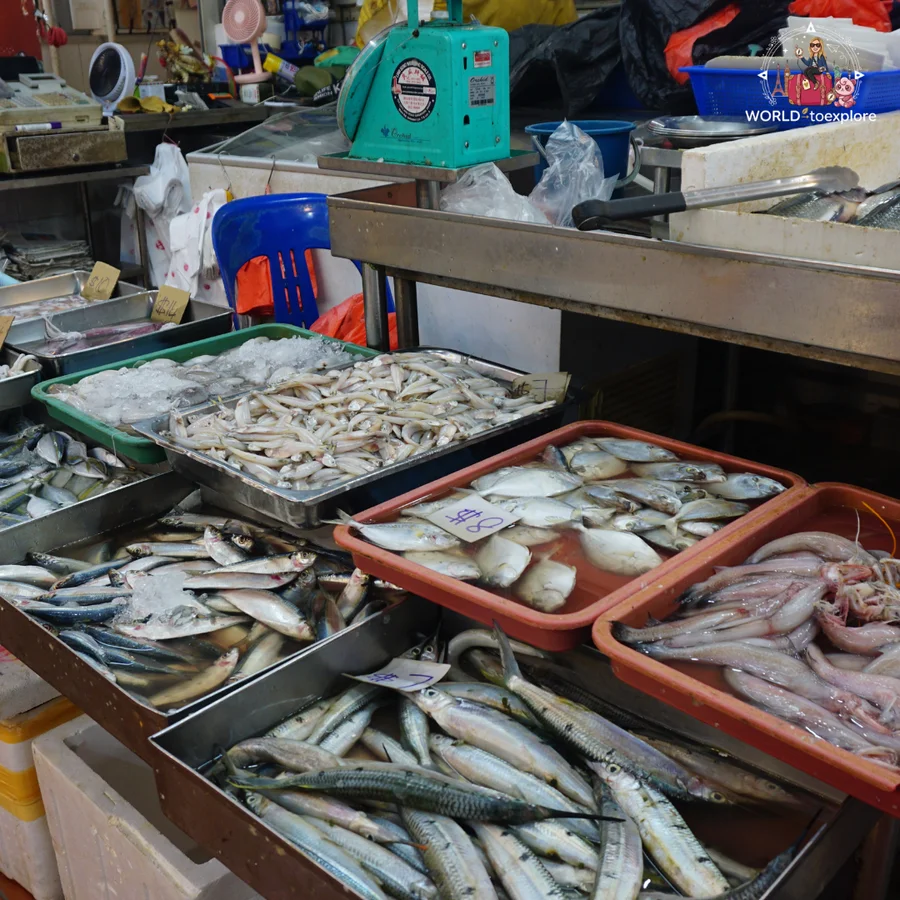 Trays of fresh fish, with sardines, mackerel and squid, at a market stall in Little India