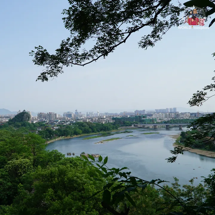 View of the Li River and the city of Guilin, framed by tree branches