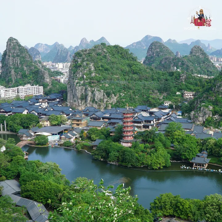 Aerial view of a lakeside area in Guilin, with a red pagoda surrounded by water and karst mountains