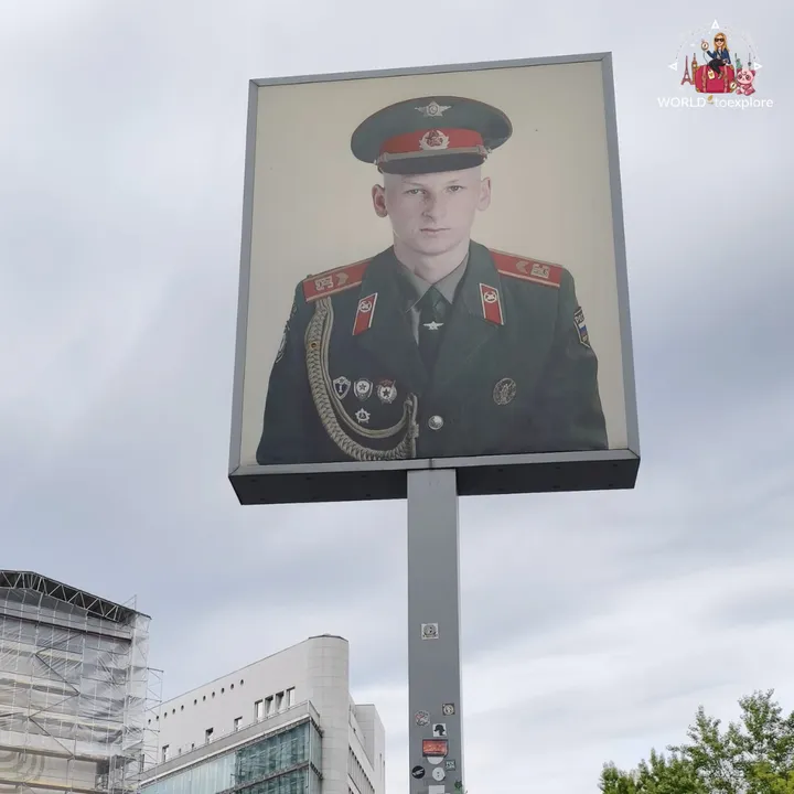 The panel with the portrait of a Soviet soldier, high on a post next to Checkpoint Charlie