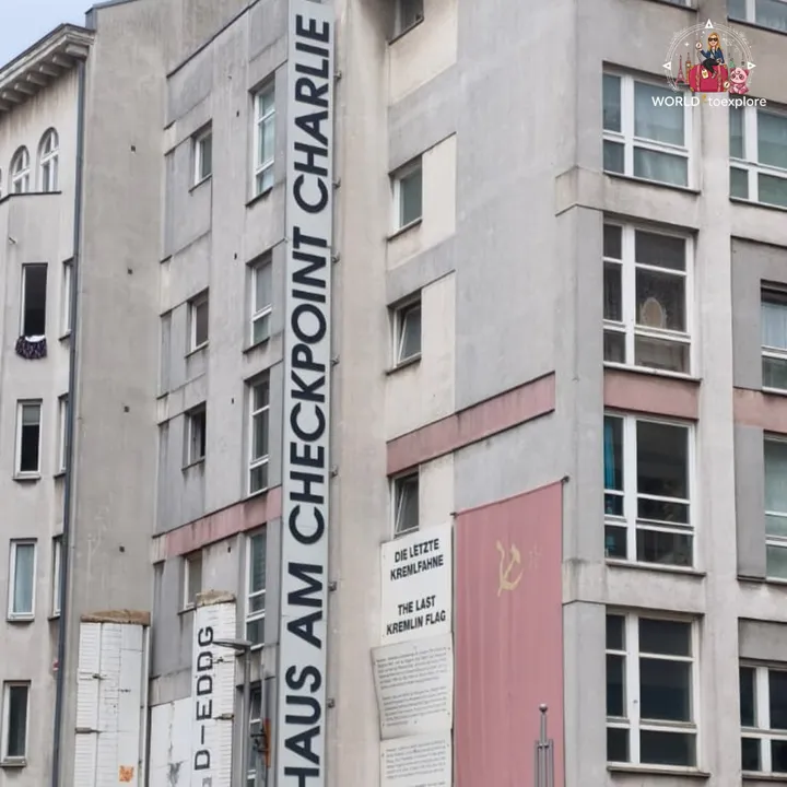 The facade of the Haus am Checkpoint Charlie building, with the last Kremlin flag painted in red on the wall
