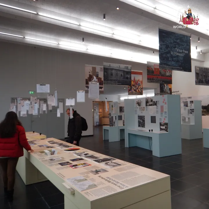 Inside the documentation centre, between panels of photographs and tables of exhibition documents