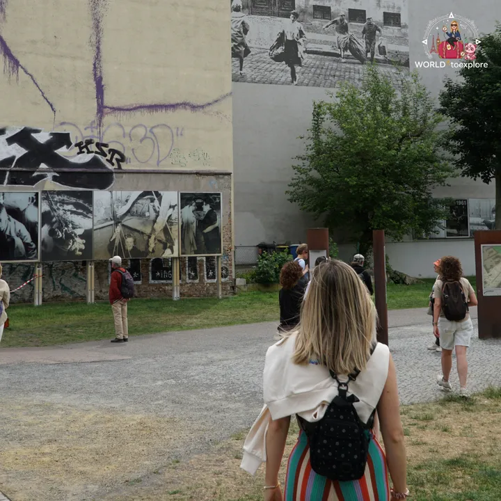 Looking at the panels of historic photographs and the iron posts marking the course of the wall, in the memorial's outdoor area