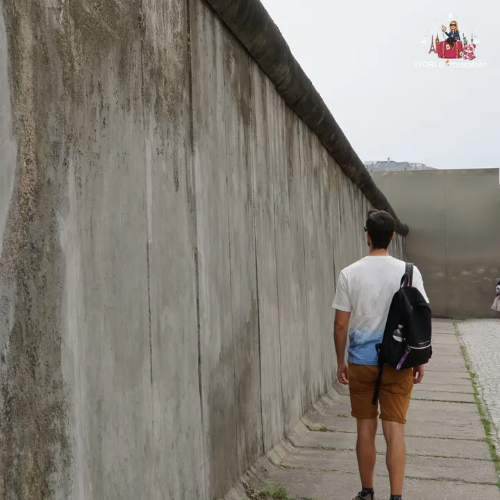 Walking along a preserved stretch of the wall, with the round pipe running along the top