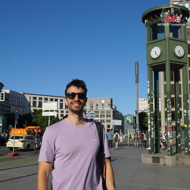 At Potsdamer Platz, next to the green traffic tower, with the square's high-rises behind