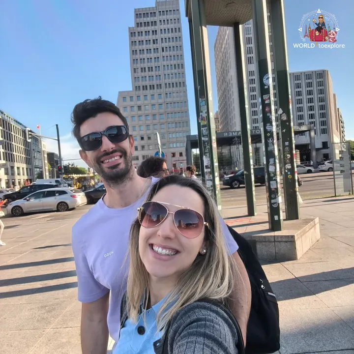 A selfie at Potsdamer Platz, beside the green traffic tower, with the tall buildings of the square behind