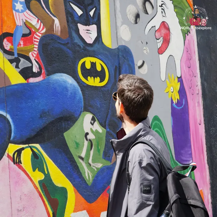 Looking at an East Side Gallery mural featuring Batman and other comic-book characters