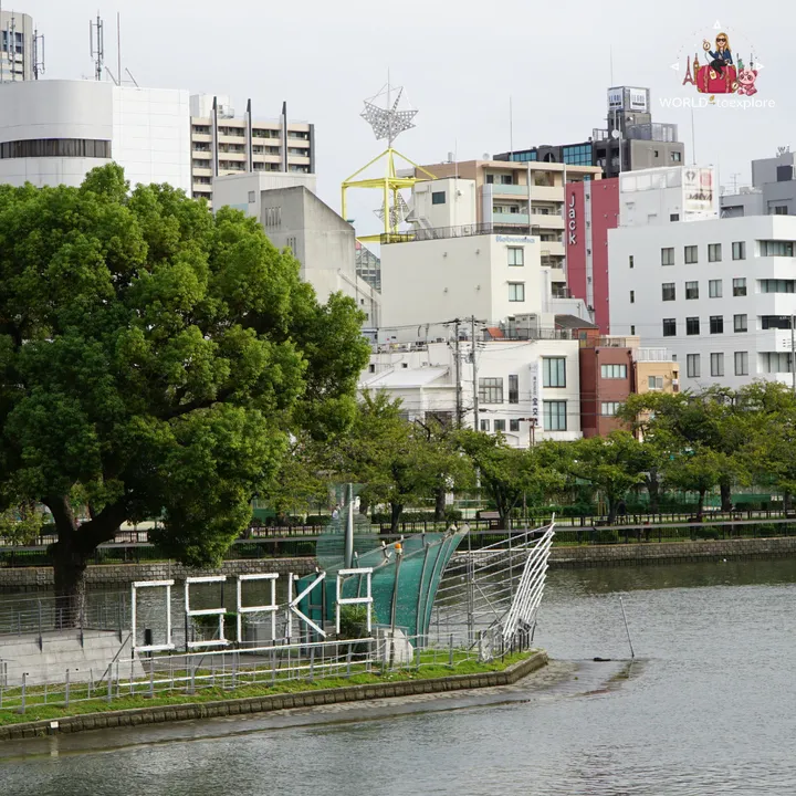 Three-dimensional OSAKA sign by the river in Nakanoshima, with city buildings in the background