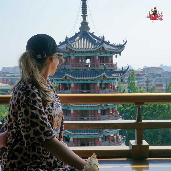 Cristina looking at the Moon Pagoda up close, with the city and Guilin’s karst mountains in the background