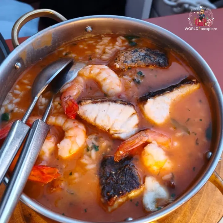 The Arroz de Mar served in a pan, soupy, with prawns and pieces of fresh fish