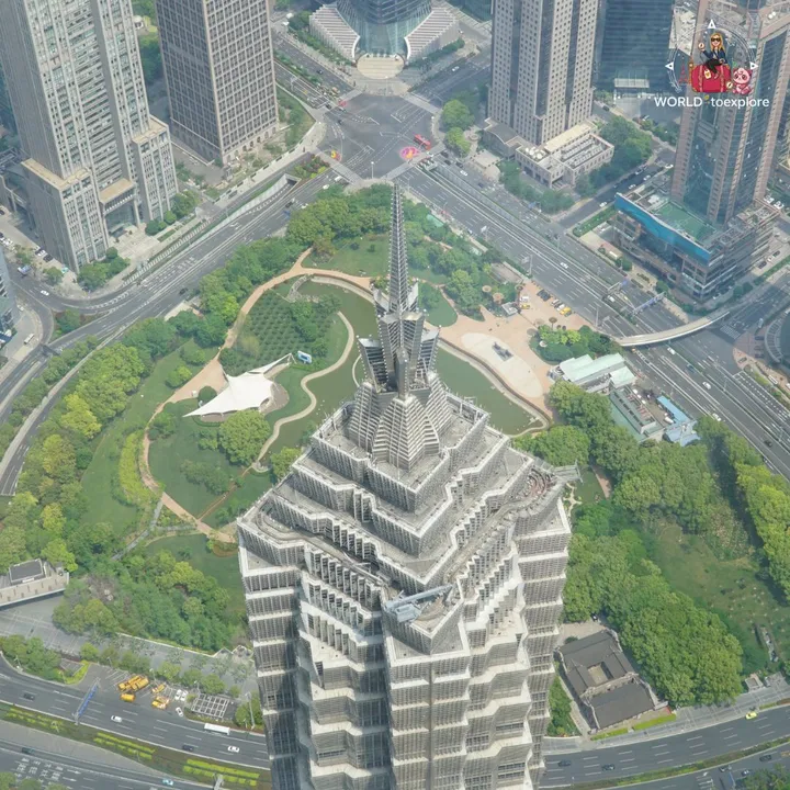 Straight-down view over the top of the Jin Mao Tower and the surrounding park, from high up the Shanghai Tower