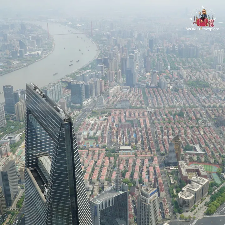 The Shanghai World Financial Center and the neighbourhoods of Puxi by the river, seen from above