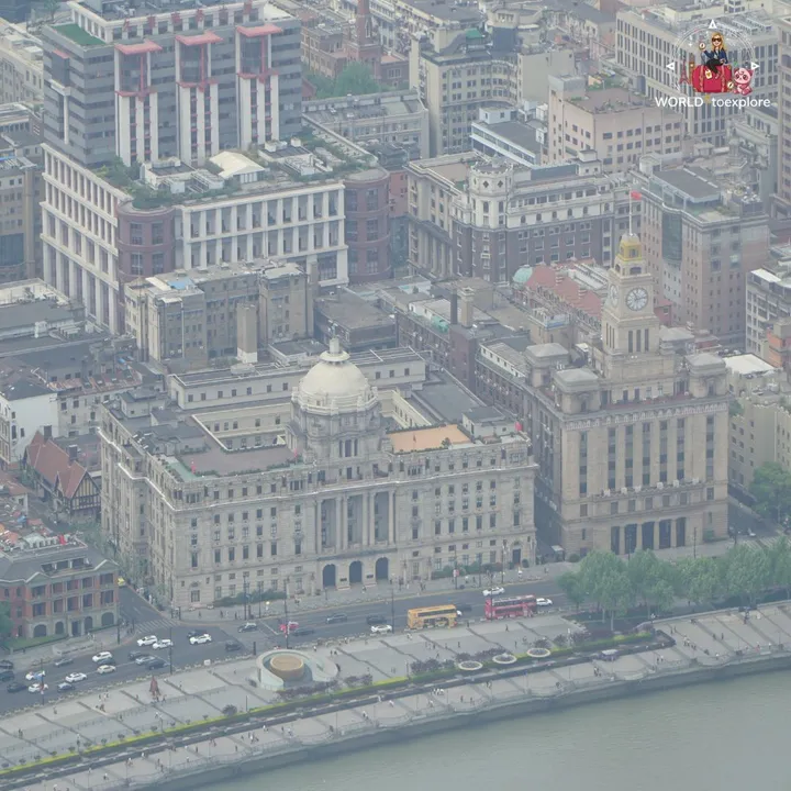 Close-up of the historic Bund buildings - the former customs house and the clock tower - by the Huangpu River