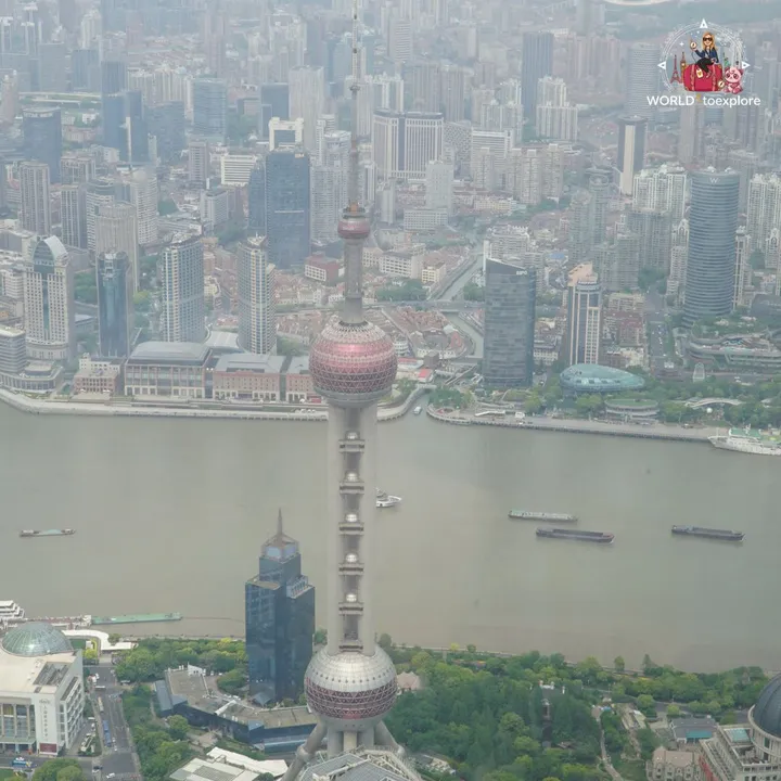 The Oriental Pearl Tower with the Huangpu River and the dense urban sprawl of Puxi behind it