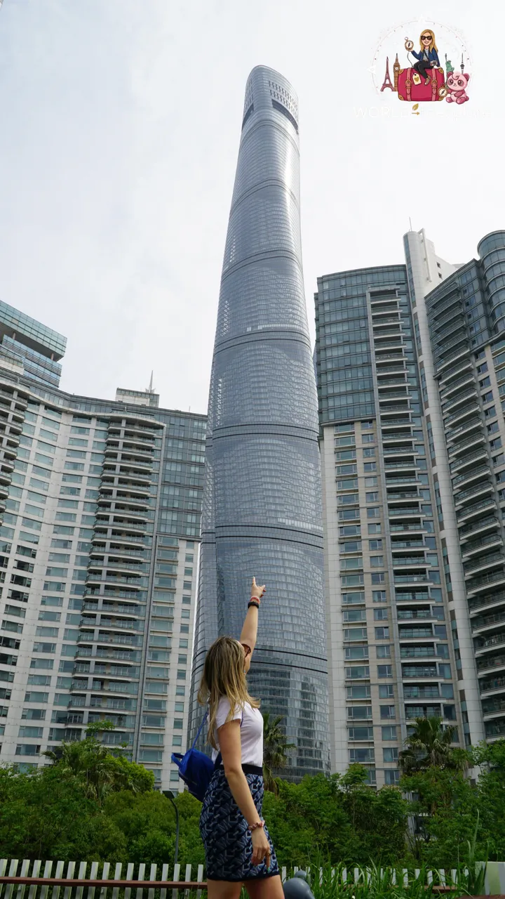 The author pointing up at the Shanghai Tower, seen from the base among the skyscrapers of Lujiazui