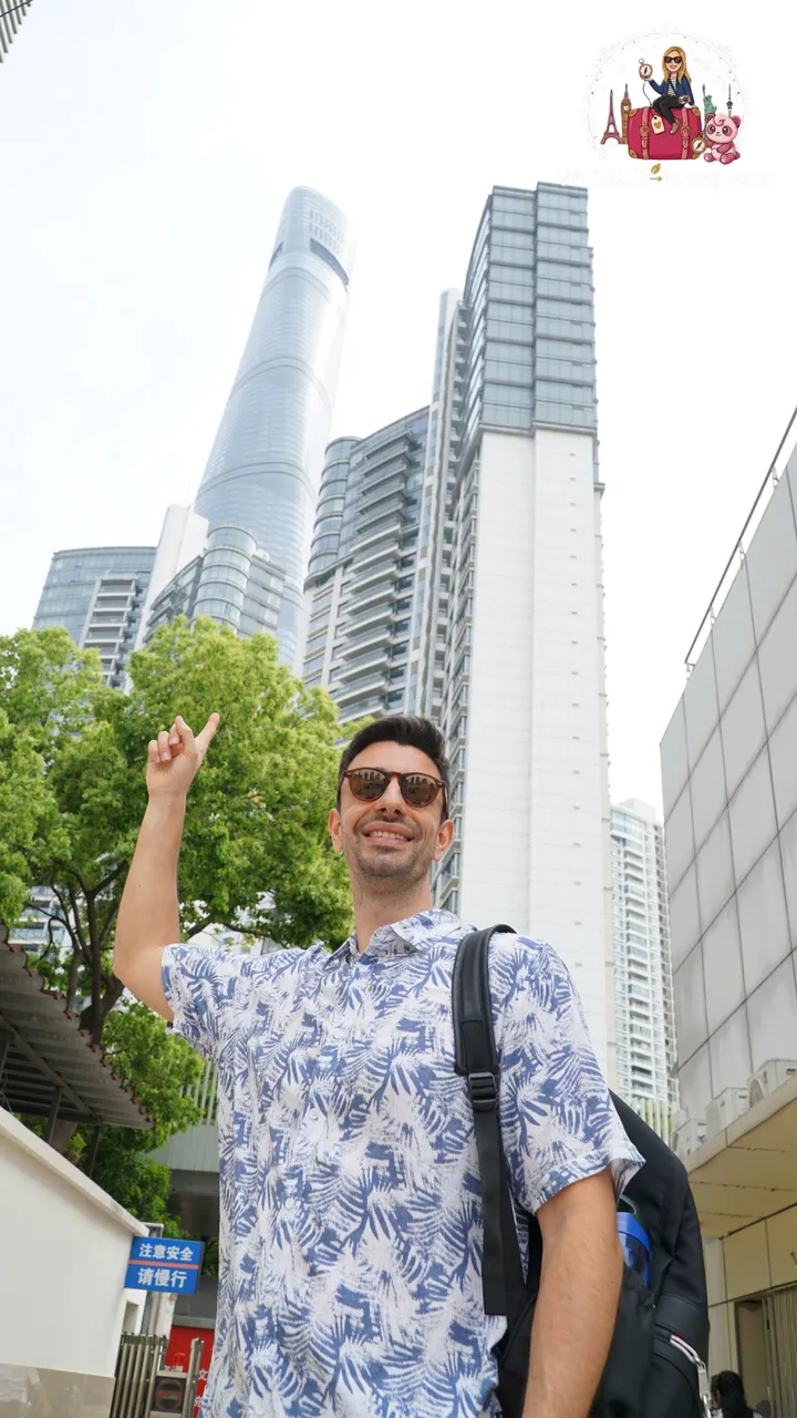 My partner pointing up at the top of the Shanghai Tower, among the buildings of Lujiazui