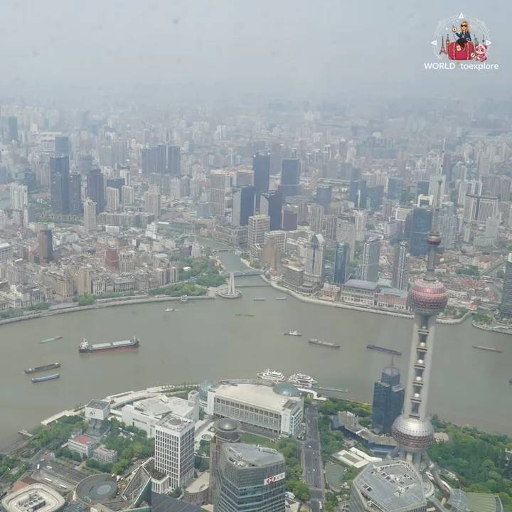 Aerial view over the bend of the Huangpu River and the top of the Oriental Pearl, from the observation deck