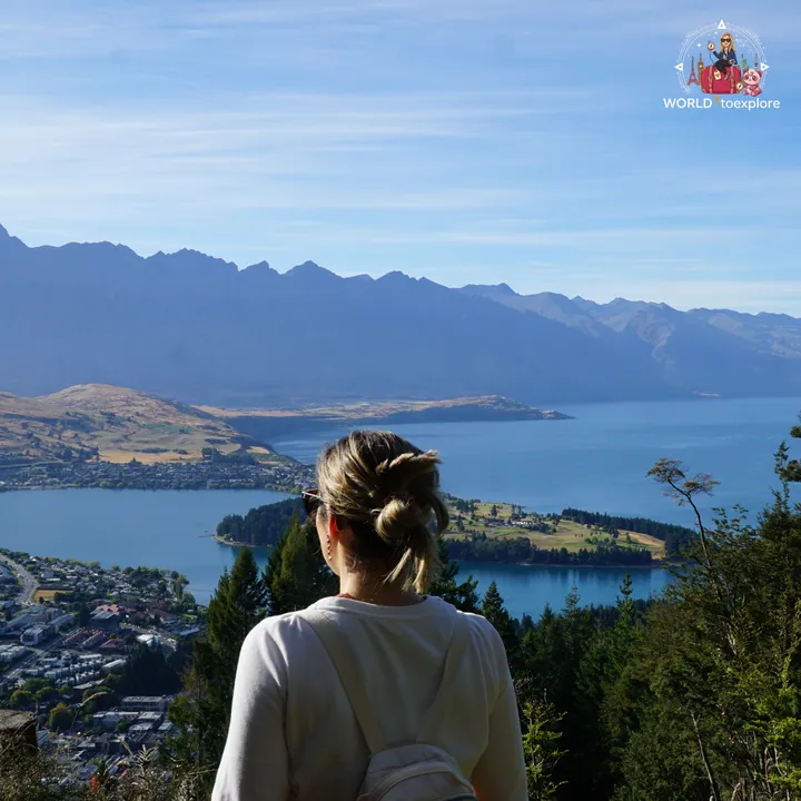 The author seen from behind admiring the view over Queenstown and Lake Wakatipu, with the mountains in the background