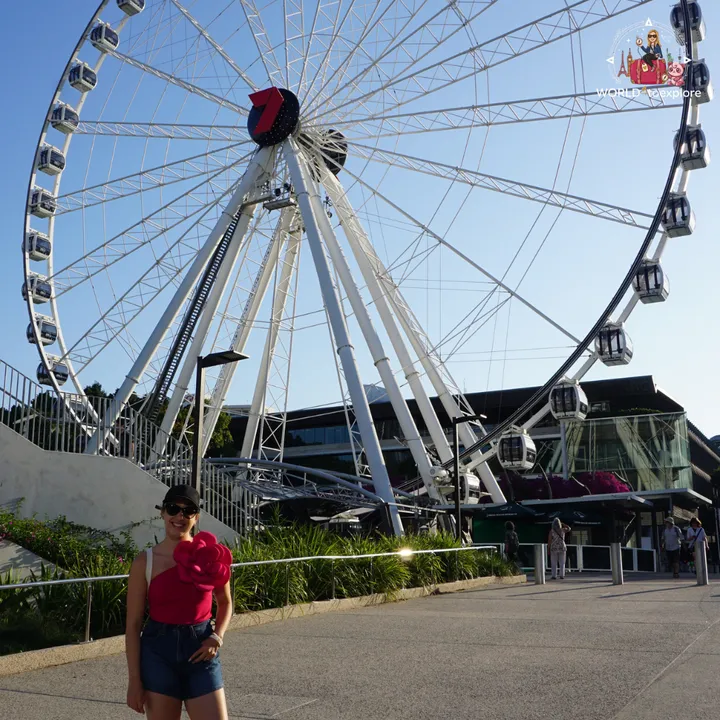 The Wheel of Brisbane in the late afternoon, with its cabins and the skyscrapers behind