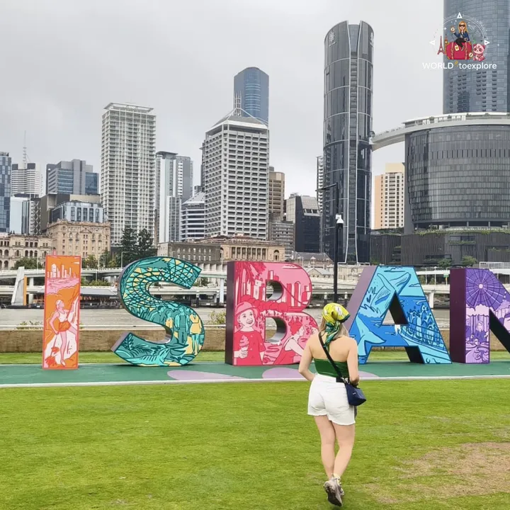 Walking towards the 'BRISBANE' sign, with the illustrated letters and the skyscrapers behind
