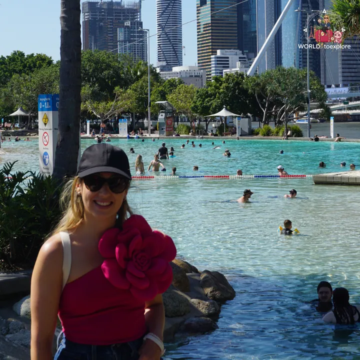 Posing beside Streets Beach, with the lagoon and the Brisbane skyscrapers behind