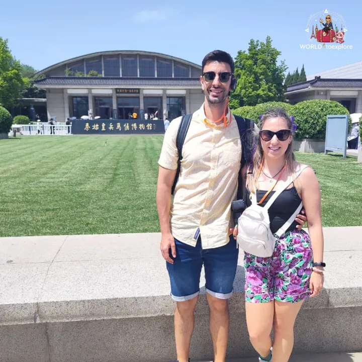 The couple in front of the Pit 1 building of the Terracotta Army Museum