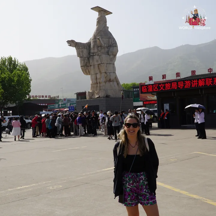 The author in the entrance plaza of the Terracotta Army, with the statue of Emperor Qin Shi Huang in the background
